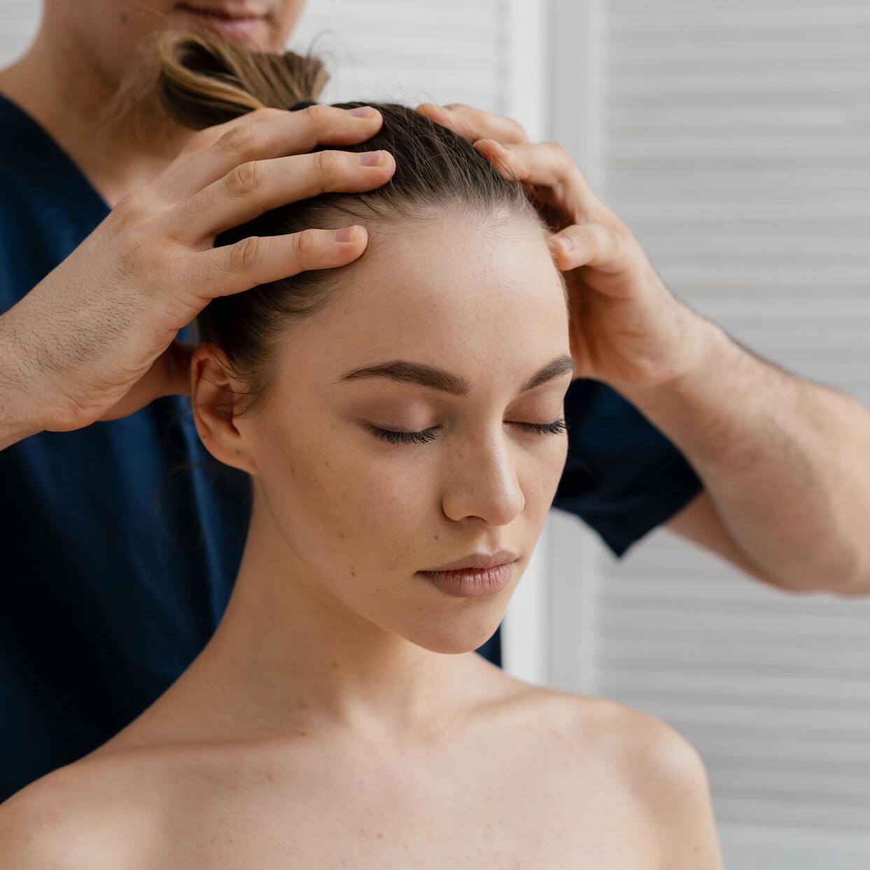 close up hands massaging scalp -