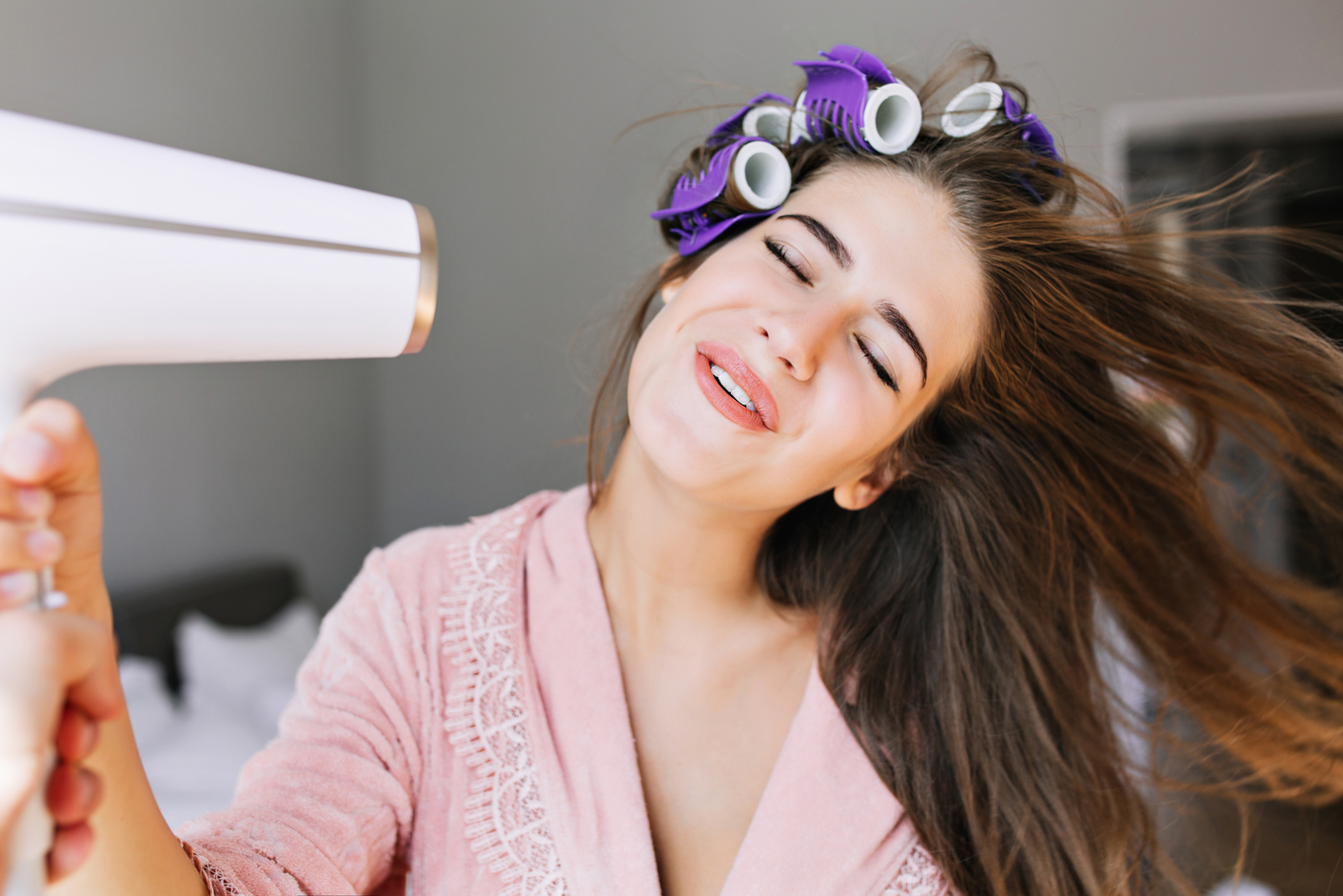 portrait pretty housewife pink bathrobe with curler home she looks enjoyed drying hair -