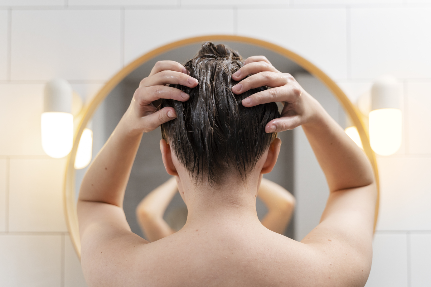 young woman applying anti dandruff product 1 -