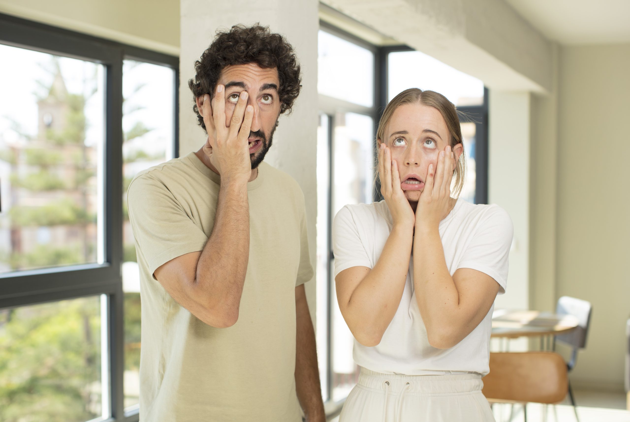 feeling shocked scared looking bored with hands cheeks scaled -
