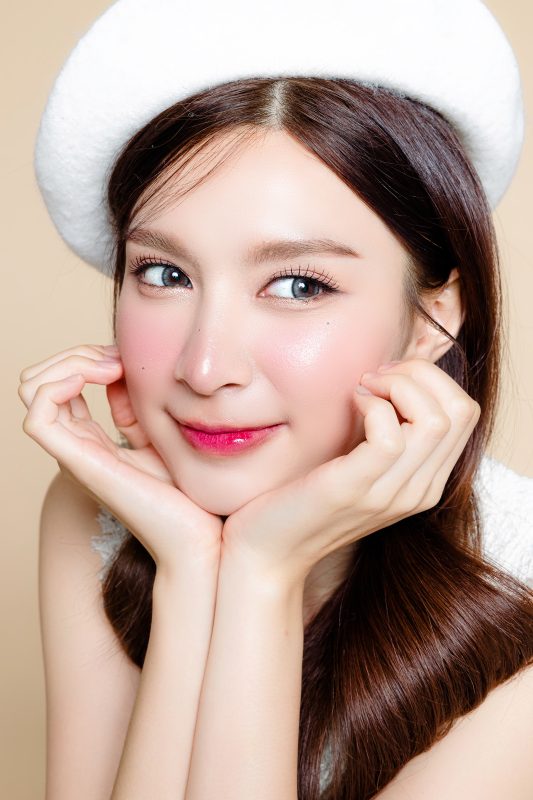 cute asian woman with perfect clear fresh skin pretty girl model wearing white beret natural makeup beige background cosmetology beauty spa wellness plastic surgery -