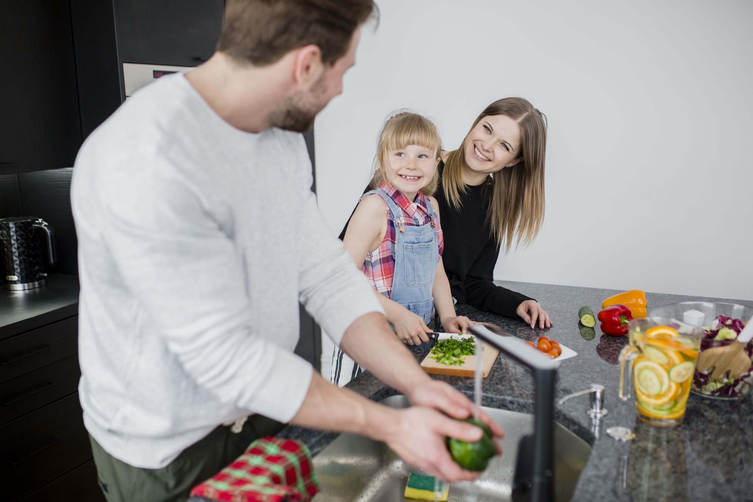 mother daughter looking man washing pepper scaled -