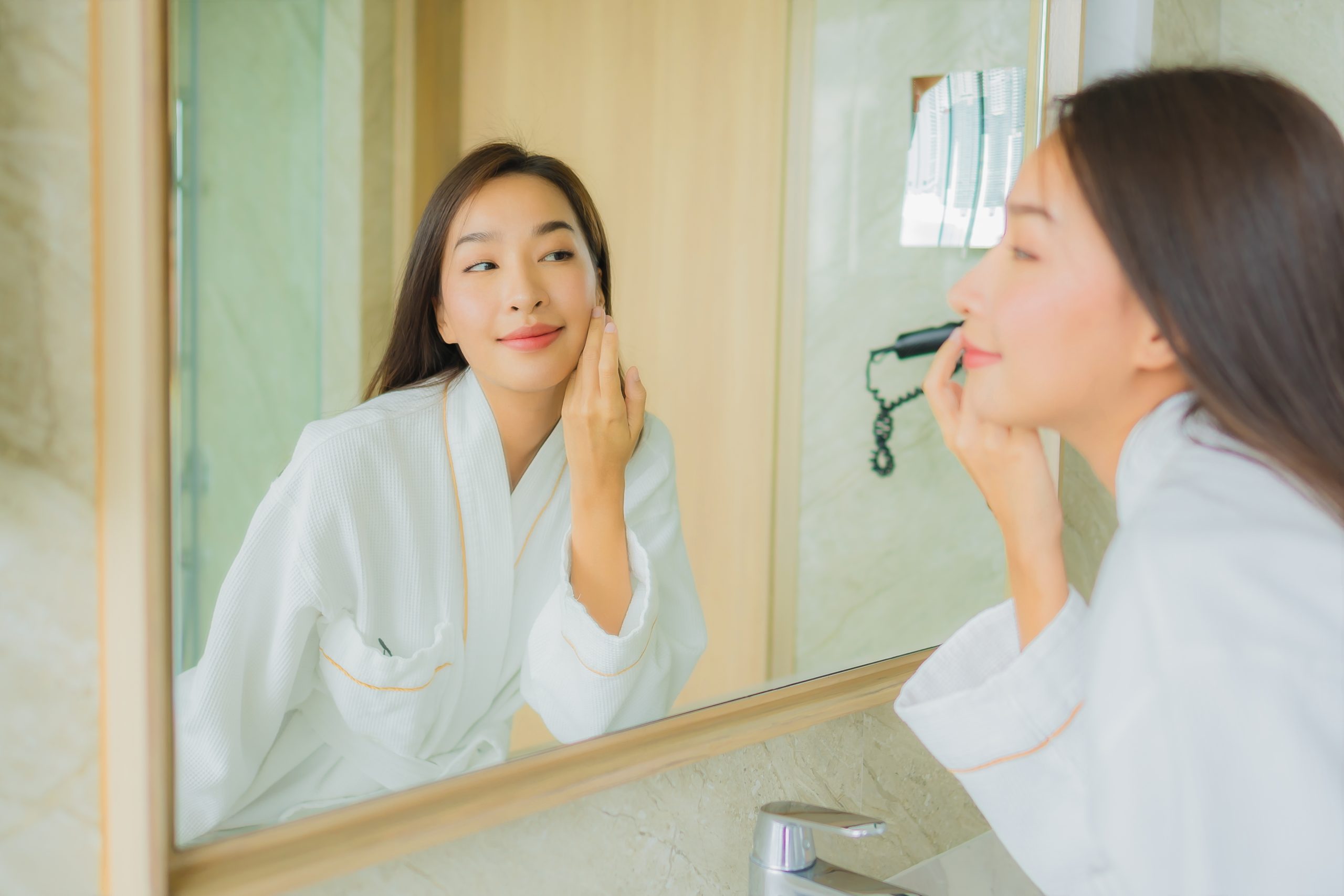 portrait beautiful young asian woman check up face bathroom scaled -